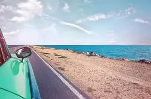 Car on beach road