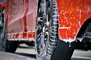 red car covered in soapy water