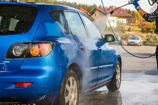 blue car being jet washed