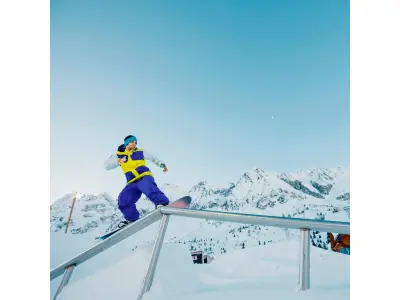 snowboarder on rail at snowpark