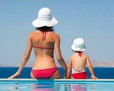 Mother and child by swimming pool